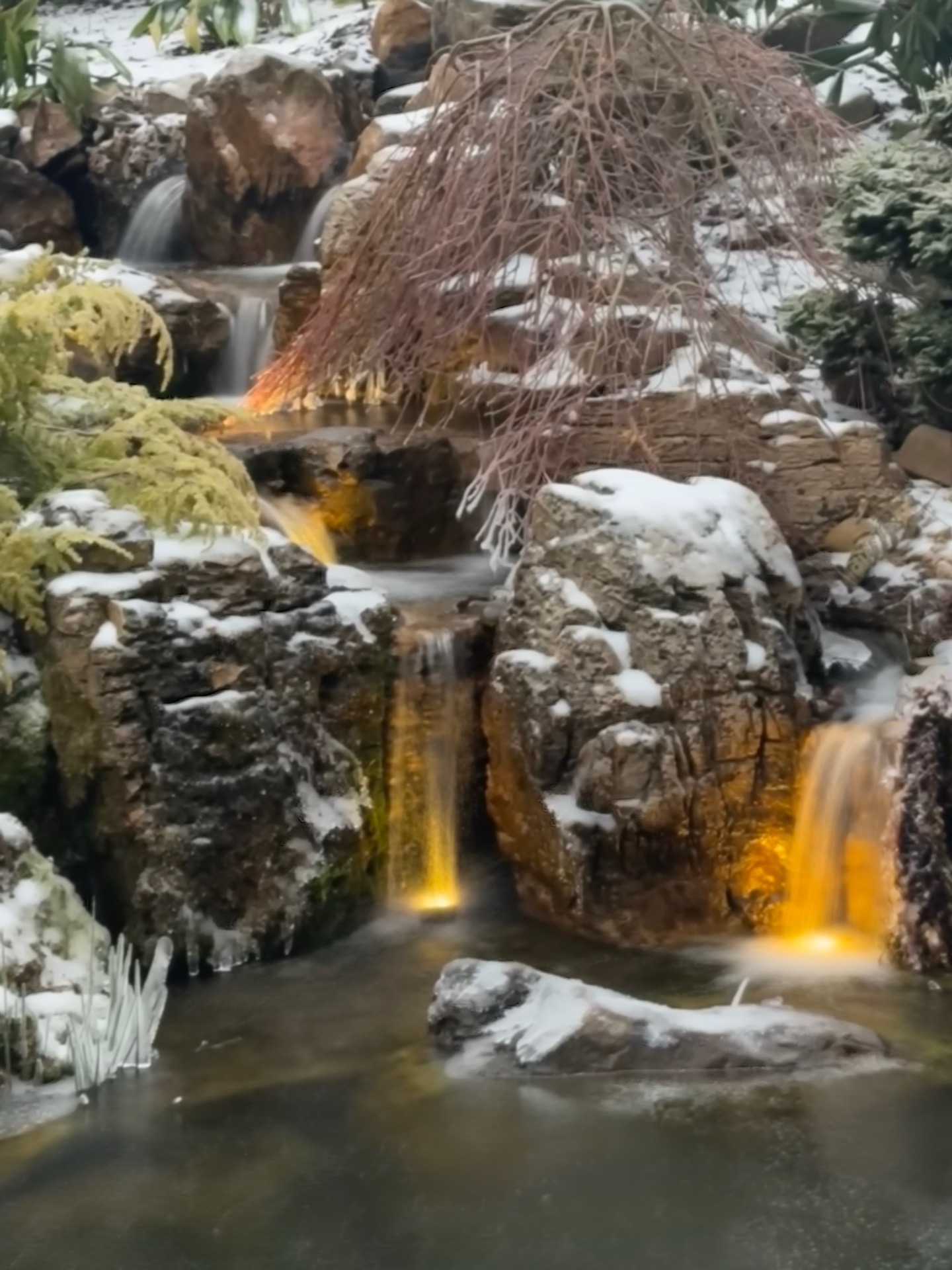 Illuminated waterfall feature in winter